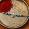 Silver Divine Blessing Rakhi – Power & Protection on Blue Thread